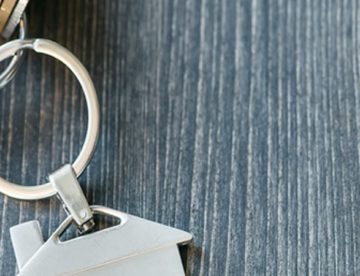 Key ring with a small house charm on the ring.