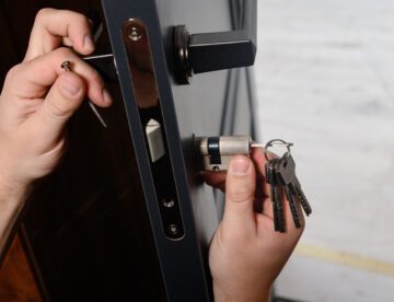 residential locksmith hands installing door lock